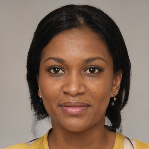Joyful black young-adult female with medium  black hair and brown eyes