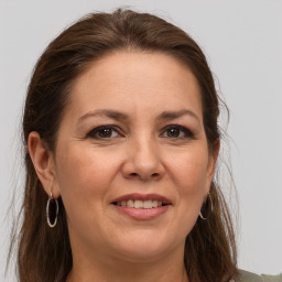 Joyful white adult female with long  brown hair and grey eyes