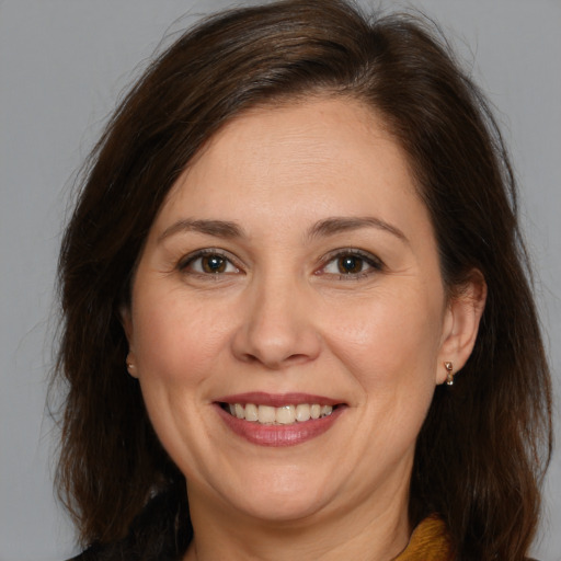 Joyful white adult female with medium  brown hair and brown eyes