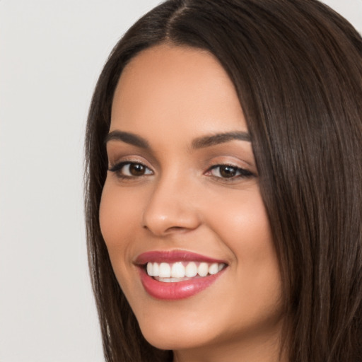 Joyful white young-adult female with long  black hair and brown eyes