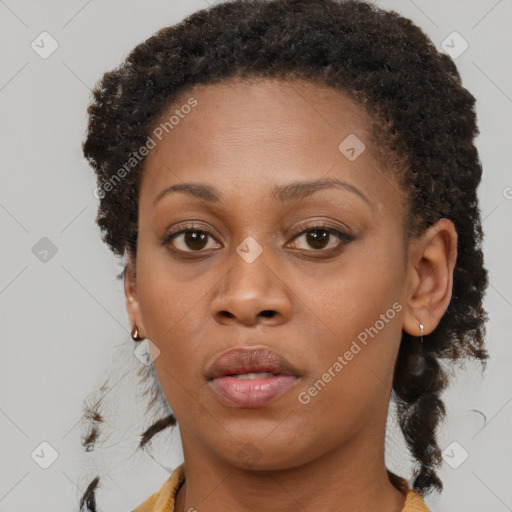 Neutral black young-adult female with medium  brown hair and brown eyes