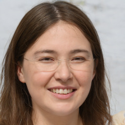 Joyful white adult female with long  brown hair and brown eyes