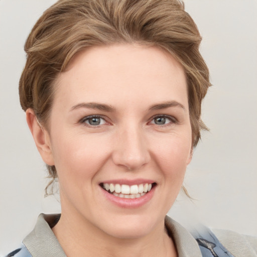 Joyful white young-adult female with short  brown hair and grey eyes