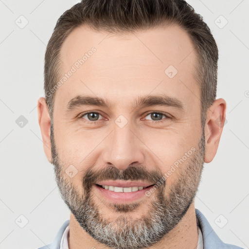 Joyful white adult male with short  brown hair and brown eyes