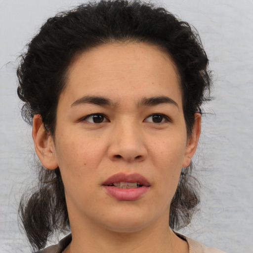Joyful asian adult female with medium  brown hair and brown eyes
