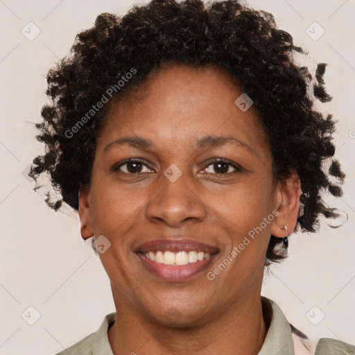 Joyful black adult female with short  brown hair and brown eyes