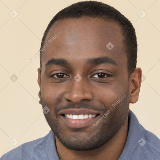 Joyful black young-adult male with short  brown hair and brown eyes