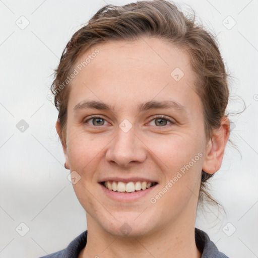 Joyful white young-adult female with short  brown hair and grey eyes