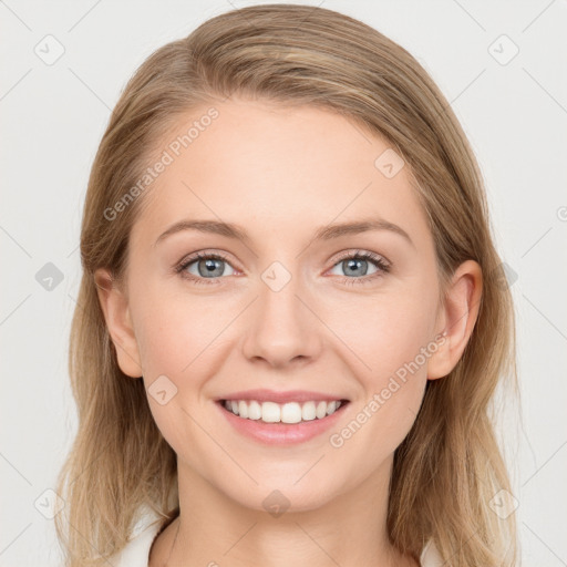 Joyful white young-adult female with long  brown hair and blue eyes