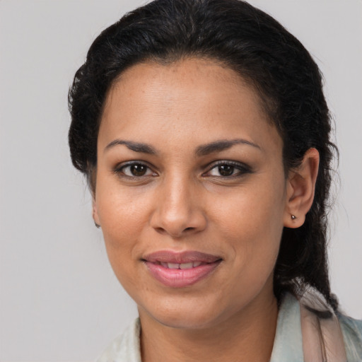 Joyful latino adult female with medium  brown hair and brown eyes