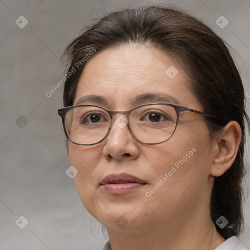 Joyful white adult female with medium  brown hair and brown eyes