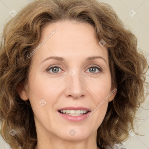 Joyful white adult female with medium  brown hair and green eyes