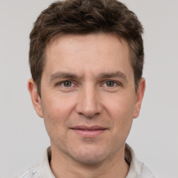 Joyful white adult male with short  brown hair and brown eyes