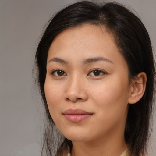 Joyful asian young-adult female with long  brown hair and brown eyes