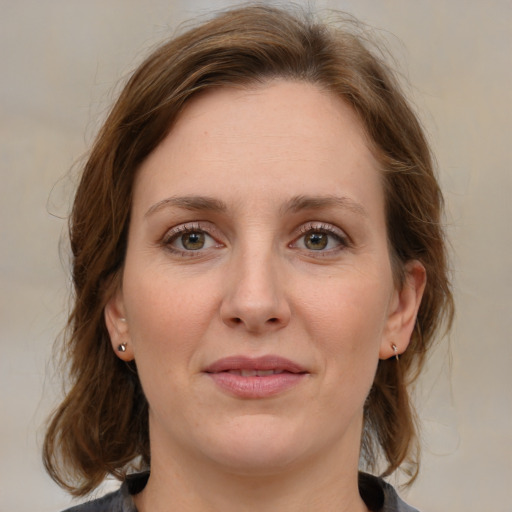 Joyful white young-adult female with medium  brown hair and blue eyes