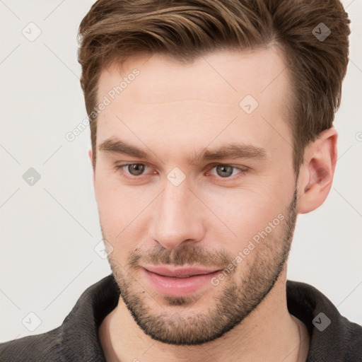 Joyful white young-adult male with short  brown hair and grey eyes