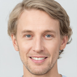 Joyful white adult male with short  brown hair and grey eyes