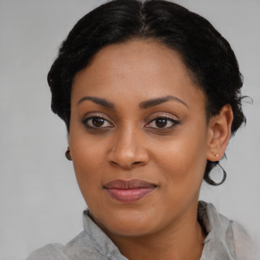 Joyful black young-adult female with medium  black hair and brown eyes