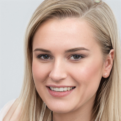 Joyful white young-adult female with long  brown hair and grey eyes