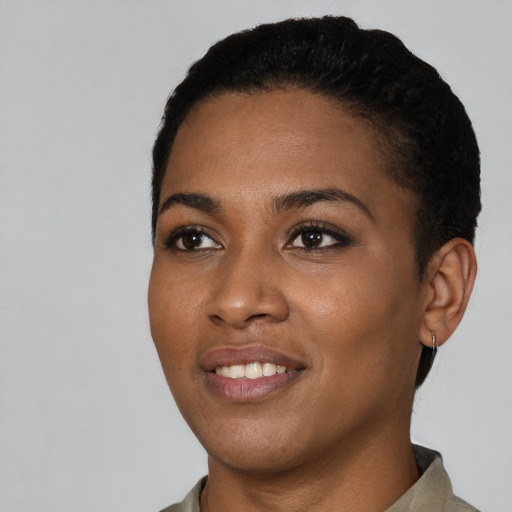 Joyful black young-adult female with short  black hair and brown eyes