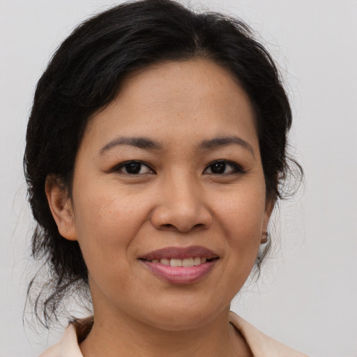 Joyful asian adult female with medium  brown hair and brown eyes