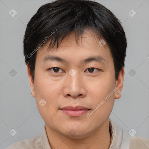 Joyful asian young-adult male with short  brown hair and brown eyes