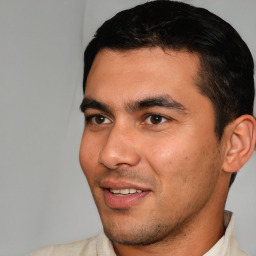 Joyful white young-adult male with short  black hair and brown eyes