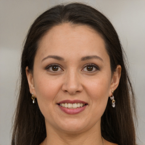 Joyful white young-adult female with long  brown hair and brown eyes