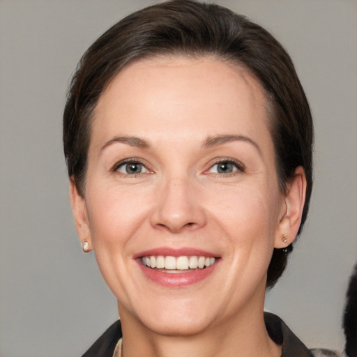 Joyful white adult female with short  brown hair and brown eyes