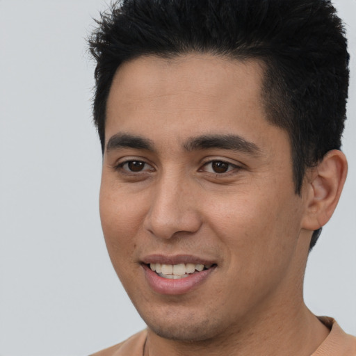 Joyful latino young-adult male with short  brown hair and brown eyes