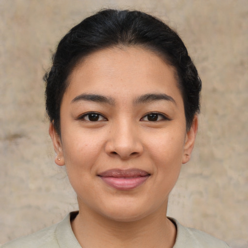 Joyful asian young-adult female with short  brown hair and brown eyes