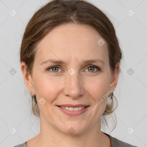 Joyful white adult female with medium  brown hair and grey eyes