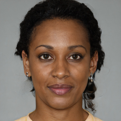 Joyful black adult female with short  brown hair and brown eyes