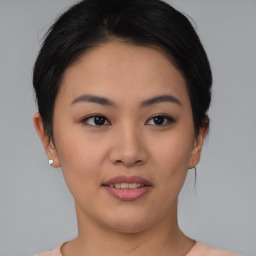 Joyful asian young-adult female with short  brown hair and brown eyes