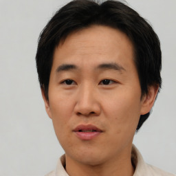 Neutral asian adult male with short  brown hair and brown eyes