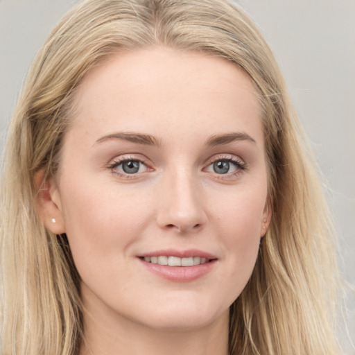 Joyful white young-adult female with long  brown hair and blue eyes