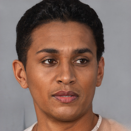 Joyful latino young-adult male with short  brown hair and brown eyes