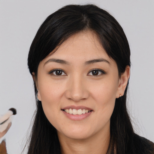 Joyful asian young-adult female with long  black hair and brown eyes