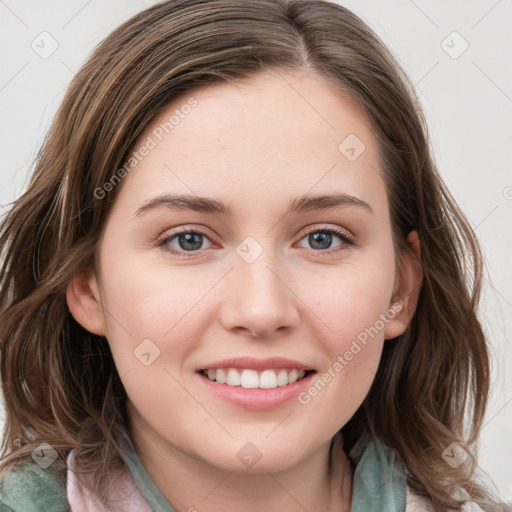 Joyful white young-adult female with medium  brown hair and blue eyes