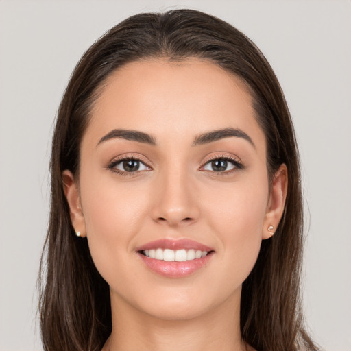 Joyful white young-adult female with long  brown hair and brown eyes