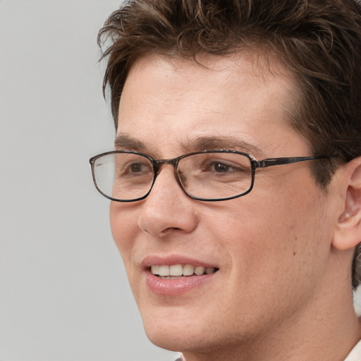 Joyful white adult male with short  brown hair and grey eyes