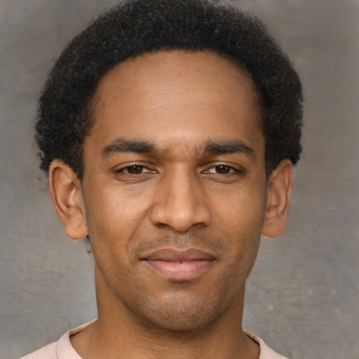 Joyful latino young-adult male with short  brown hair and brown eyes