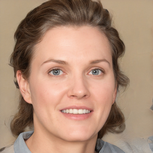 Joyful white young-adult female with medium  brown hair and blue eyes