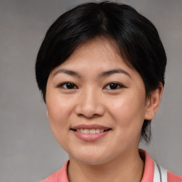 Joyful asian young-adult female with medium  brown hair and brown eyes