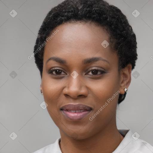 Joyful black young-adult female with short  black hair and brown eyes