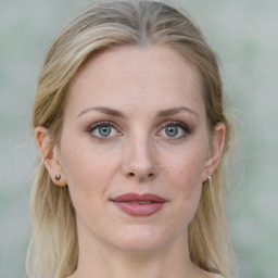 Joyful white adult female with medium  brown hair and blue eyes