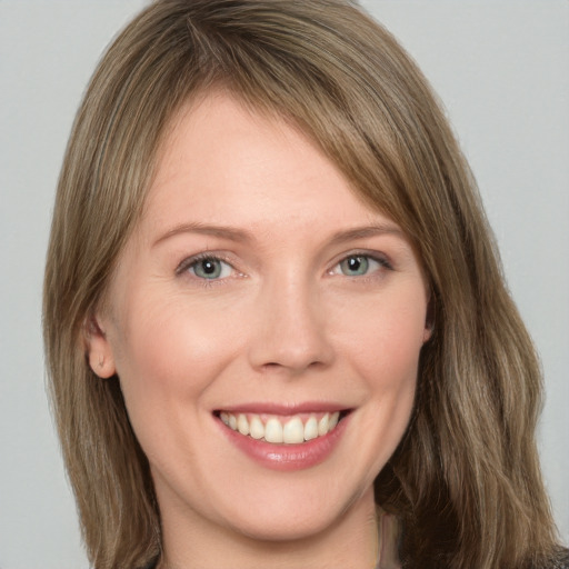 Joyful white young-adult female with medium  brown hair and grey eyes