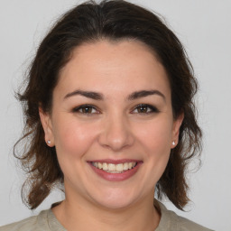 Joyful white young-adult female with medium  brown hair and brown eyes