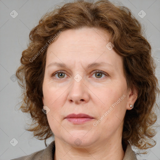 Joyful white adult female with medium  brown hair and blue eyes