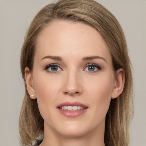 Joyful white young-adult female with medium  brown hair and grey eyes